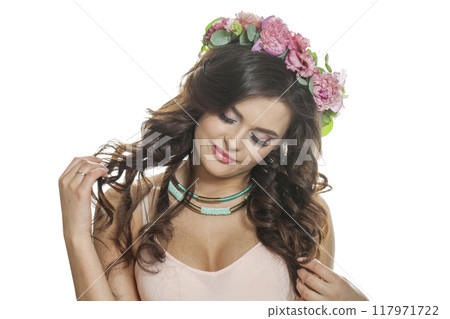 Smiling summer woman with long dark wavy hair, clean shiny skin and pink flower crown 117971722