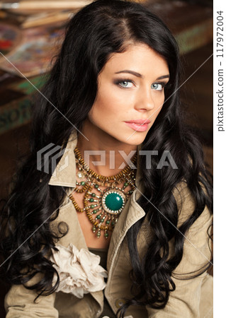 Cheerful young adult woman with long wavy hair and make-up fashion portrait 117972004