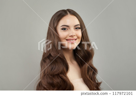 Smiling happy young female model with natural make-up, shiny clean skin and perfect hair. Smiling happy young female model with natural make-up, shiny clean skin and perfect hair. 117972101