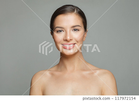 Lovely happy young female model with natural make-up, shiny clean skin and perfect smile. 117972154