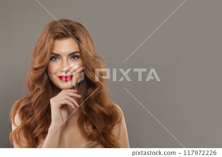 Cute happy young redhead female model with natural make-up, shiny clean skin and perfect hair. 117972226