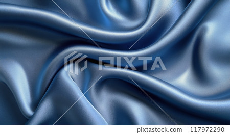 Elegant blue satin fabric draped smoothly on a surface, creating soft wave patterns 117972290