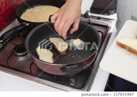 Fry white loaf croutons in a frying pan. Cook breakfast. Fry white loaf croutons in a frying pan. Cook breakfast. 117972497