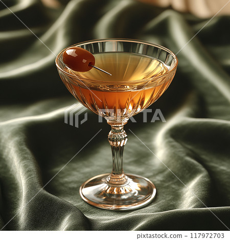 A glass of wine with a cherry on top 117972703