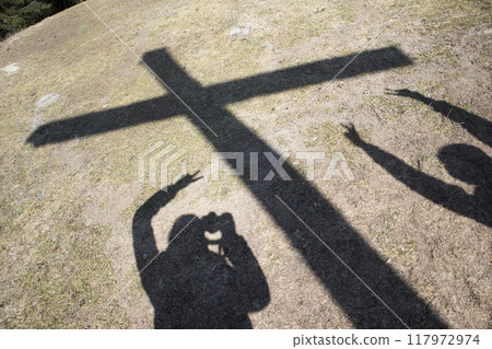 Shadow summit cross of Rechelberg mountain in springtime, Bavaria, Germany 117972974