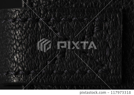 Black leather product closeup on a black background. 117973318
