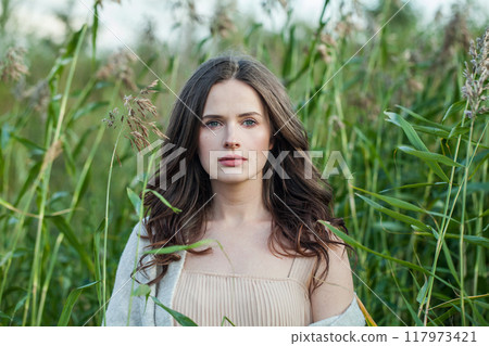 Gorgeous healthy brunette woman with long hairstyle and fresh skin walking outdoors Gorgeous healthy brunette woman with long hairstyle and fresh skin walking outdoors 117973421