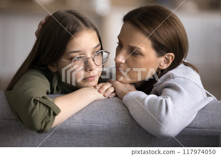 Caring mother comforting stressed upset teen daughter 117974050