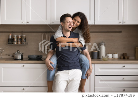 Beautiful couple spend carefree leisure in modern renovated cozy kitchen 117974199