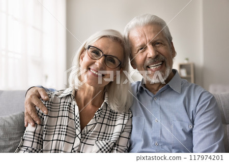 Happy well-being mature 60s spouses home portrait 117974201