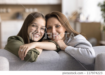 Portrait of woman posing for camera with her teenage daughter 117974223
