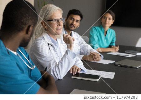 Experienced aged woman physician shares her insights with colleagues Experienced aged woman physician shares her insights with colleagues 117974298