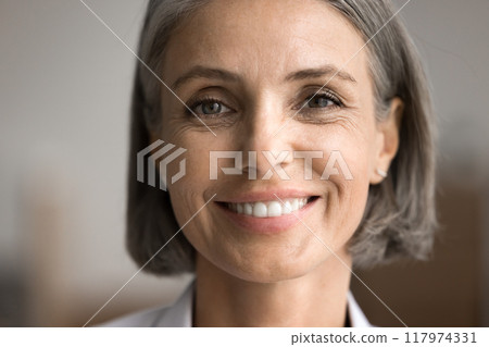 Portrait of happy middle-aged woman looking at camera 117974331