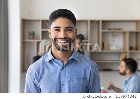 Cheerful young Arab business man posing for professional head shot 117974342