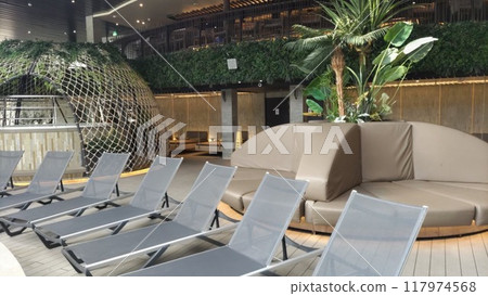 Deck chairs at resort indoor pool 117974568