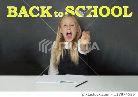 Excited kid school girl child student with yellow Back to school inscription  117974589