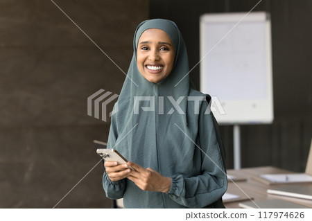 Happy Muslim young Business professional woman looking at camera Happy Muslim young Business professional woman looking at camera 117974626