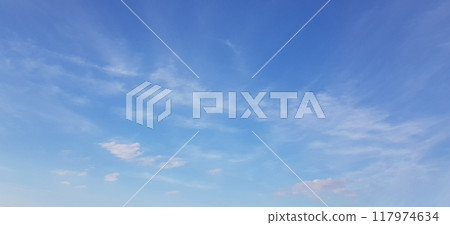 White clouds of different shapes in the blue sky, windy spring background White clouds of different shapes in the blue sky, windy spring background 117974634