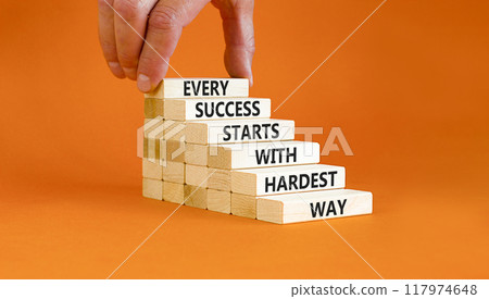 Success symbol. Concept words Every success starts with hardest way on wooden block. Beautiful orange table orange background. Businessman hand. Business success and hardest way concept. Copy space. Success symbol. Concept words Every success starts with hardest way on wooden block. Beautiful orange table orange background. Businessman hand. Business success and hardest way concept. Copy space. 117974648