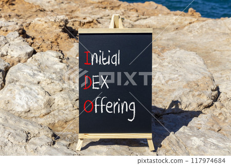 IDO initial DEX offering symbol. Concept words IDO initial DEX offering on beautiful yellow blackboard. Beautiful stone blue sky sea background. Business IDO initial DEX offering concept. Copy space. 117974684