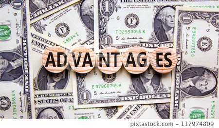 Advantages symbol. Concept word Advantages on beautiful wooden circles. Dollar bills. Beautiful background from dollar bills. Business advantages concept. Copy space. Advantages symbol. Concept word Advantages on beautiful wooden circles. Dollar bills. Beautiful background from dollar bills. Business advantages concept. Copy space. 117974809