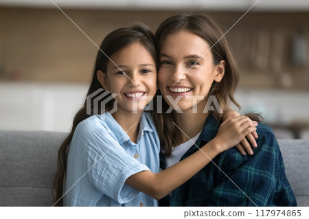 Cheerful beautiful mom and happy daughter child looking at camera 117974865