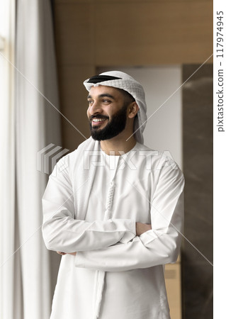 Successful happy Arabic business owner man looking at window away Successful happy Arabic business owner man looking at window away 117974945