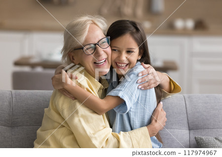 Cheerful grandkid girl and happy grandma enjoying family leisure 117974967