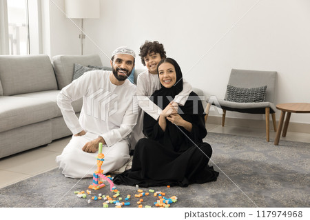 Happy Middle Eastern parents and kid posing for family portrait 117974968