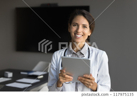 Young 30s Hispanic physician posing for cam with digital tablet Young 30s Hispanic physician posing for cam with digital tablet 117975135
