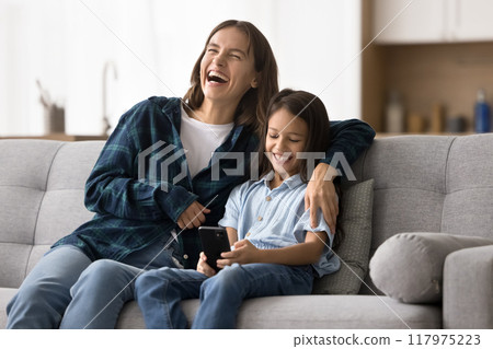 Happy excited young mother hugging adorable smart daughter kid 117975223