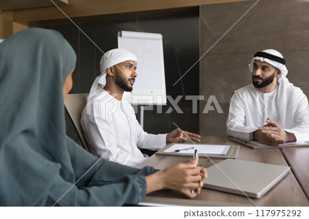 Male and female Arab colleagues brainstorming on creative ideas Male and female Arab colleagues brainstorming on creative ideas 117975292