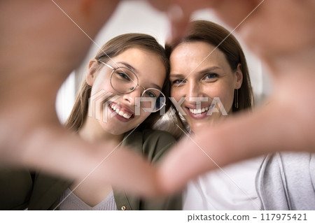 Teenager girl and caring mother showing love sign Teenager girl and caring mother showing love sign 117975421