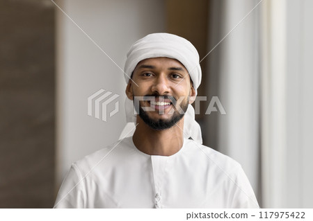 Happy handsome young Arabian business man looking at camera Happy handsome young Arabian business man looking at camera 117975422