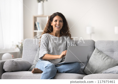 Happy woman spend time at home with laptop 117975461