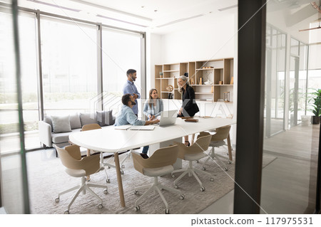 Small business group and elder leader woman talking at table Small business group and elder leader woman talking at table 117975531