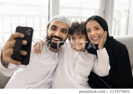 Happy Middle Eastern parents and cute son taking selfie Happy Middle Eastern parents and cute son taking selfie 117975691