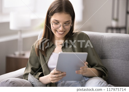 Happy teenager 16s girl browse internet use digital tablet device Happy teenager 16s girl browse internet use digital tablet device 117975714
