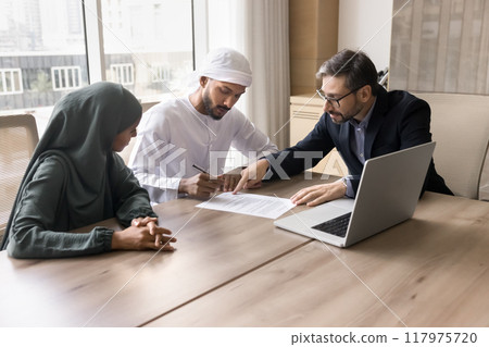 Arabic young couple of serious Arabic signing mortgage agreement Arabic young couple of serious Arabic signing mortgage agreement 117975720