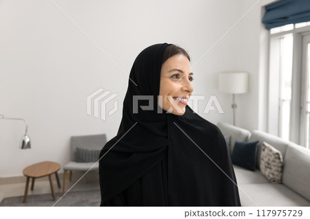 Happy attractive Arabian woman posing in home apartment 117975729