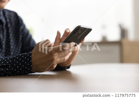 Closeup female using smartphone for business calls or communication Closeup female using smartphone for business calls or communication 117975775