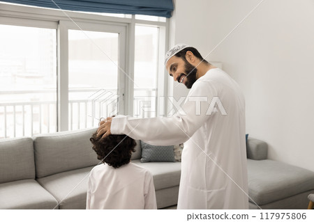 Positive Middle Eastern father cuddling little sons head Positive Middle Eastern father cuddling little sons head 117975806