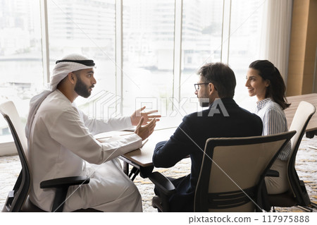 Successful young Arabian business owner man talking to European partners 117975888