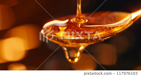drop of honey dripping from a spoon, highlighting the thick texture and golden color of the sweet liquid. Generative AI 117976103
