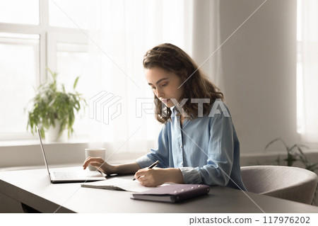 Young woman studying, preparing for school exams or university admission Young woman studying, preparing for school exams or university admission 117976202
