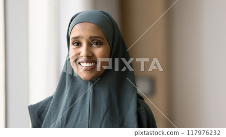 Cheerful beautiful young Arab business professional woman looking away 117976232