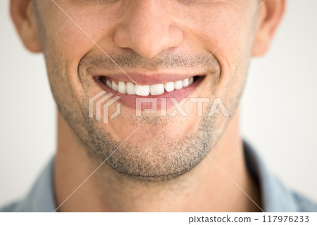 Close up of male toothy smile, shaved chin with stubble 117976233