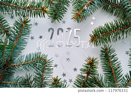 Abstract light Christmas background with stars and a Christmas tree with the year number 2025. Abstract light Christmas background with stars and a Christmas tree with the year number 2025. 117976331