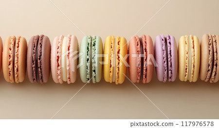 Colorful assortment of macarons displayed in a neat row on a neutral background 117976578