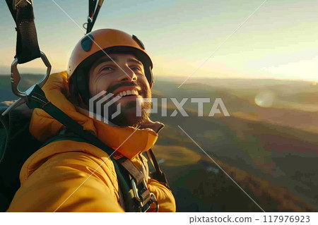 Happy paragliders flying on a paraglider, experienced pilots smiling at the camera 117976923